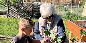 Woman and boy planting a garden