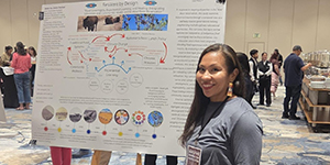 Woman presenting a research poster.