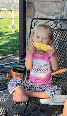Girl eating an ear of corn
