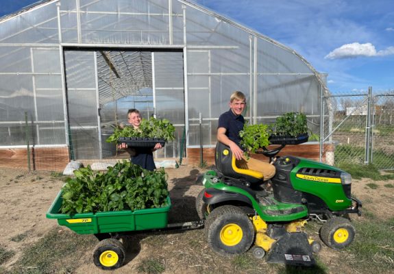 Boys with a John Deere tractor and wagon.