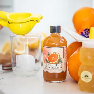 Bottle of bitters and fresh fruit.