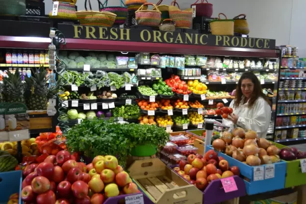A shopper selects fresh, organically grown produce at Big Hollow Food Co-Op in downtown Laramie.