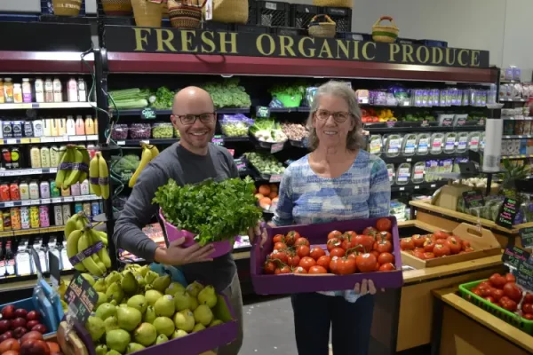Big Hollow Food Co-Op manager Jeff Hubbell and customer Sue Miller, an original member of the co-op in downtown Laramie, display fresh, organic produce.