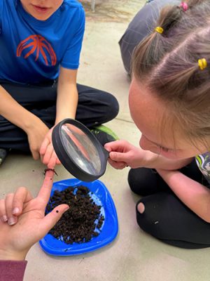 Children using a magnifying glass