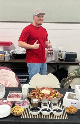 Black-Gold-Jelly-Company-2-500h Man behind table with bottles of sauces