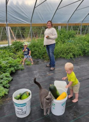 Mom and two kids in a greenhouse