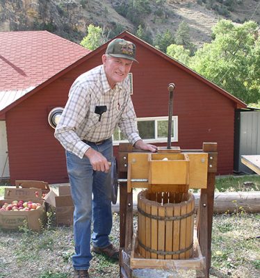 Older man pressing apples
