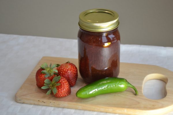 Jar of jam with strawberries and peppers