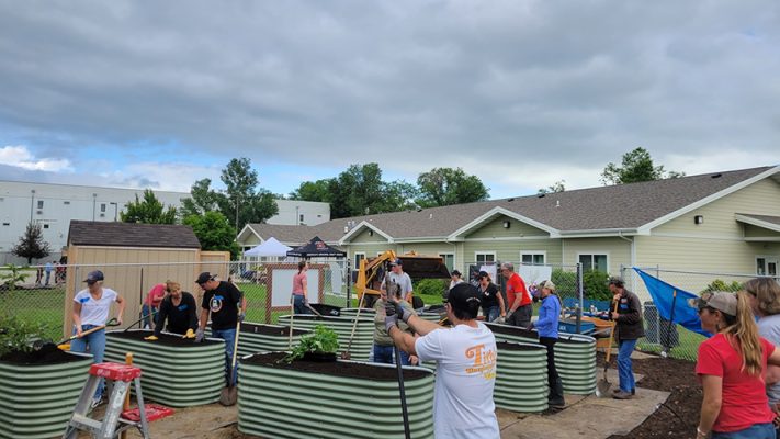 People filling raised beds