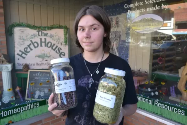 Damian Judy, a staff member at The Herb House in Laramie, displays dried hawthorn berries and hops flowers, which are among the many offerings of herbs, teas, and tinctures sourced both locally and from around the Rocky Mountains. Damian explains that the white coating on the hawthorn berries is natural sucrose maturing in the outer skin.
