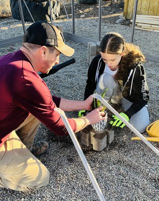 Adult and youth repotting plants
