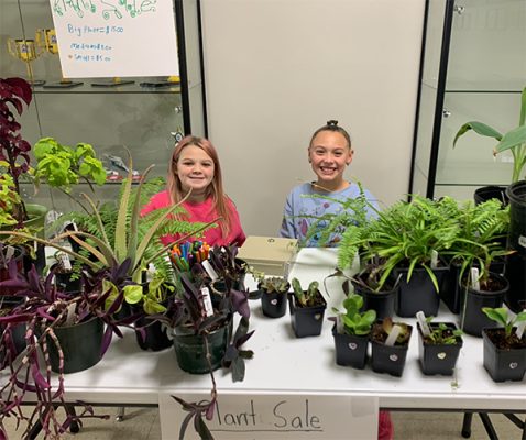 Two children with plants