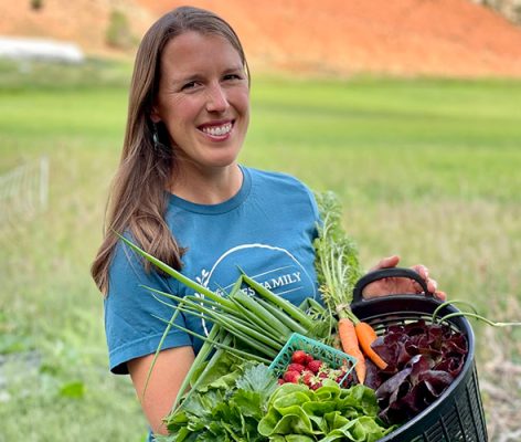 Smiling woman holding produce