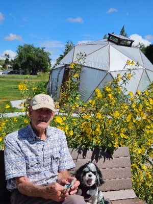 Man and dog sitting in a garden