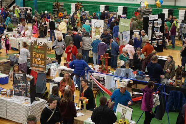 People walking around an expo.