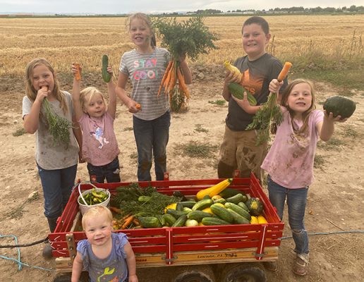 Kids holding produce.