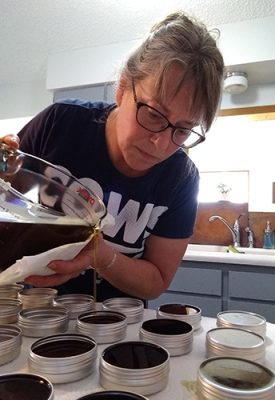 Woman pouring liquid in a kitchen