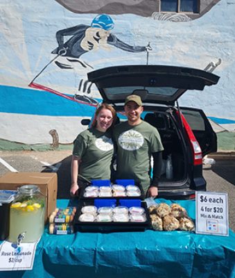 Vendors working at a farmers market.