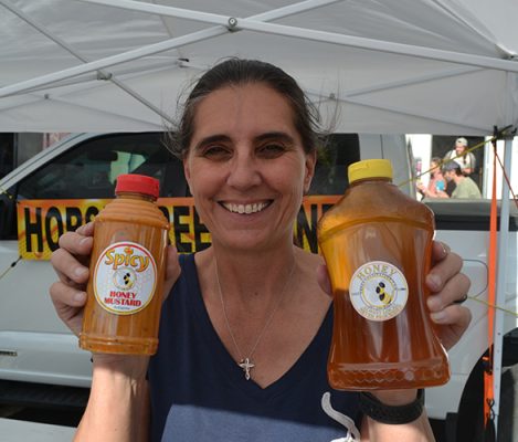 Woman holding bottles of honey