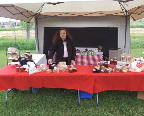 Woman behind a table with homemade products