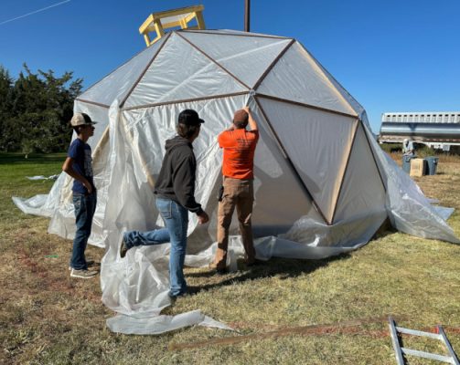 People building a hoop house