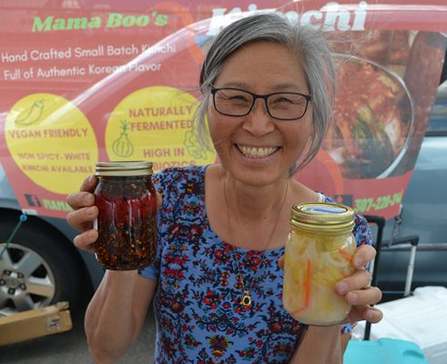 Booyong Kim holding two jars
