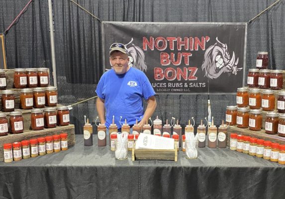 Man with jars of bbq sauce