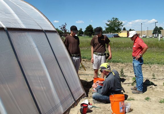 People working on a greenhouse