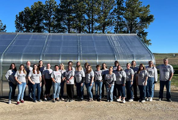 Students in front of a greenhouse