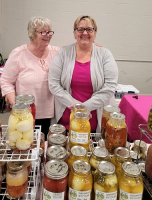 Ladies standing with canned produce