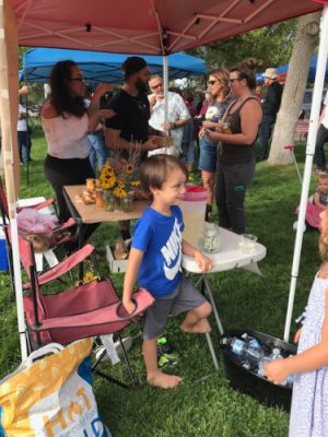 People milling around at a farmer's market.