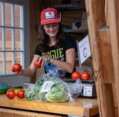 Woman bagging vegetables