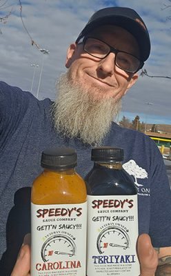 Man with bottles of sauce