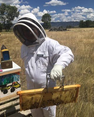 Woman holding a honey frame