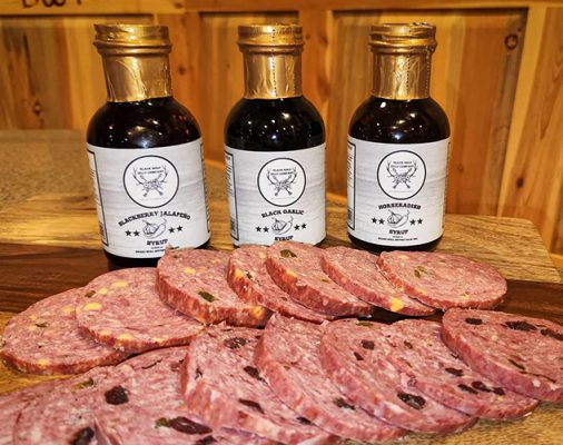 Bottles of sauces and sausage slices