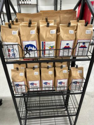 Metal stand with bags of coffee