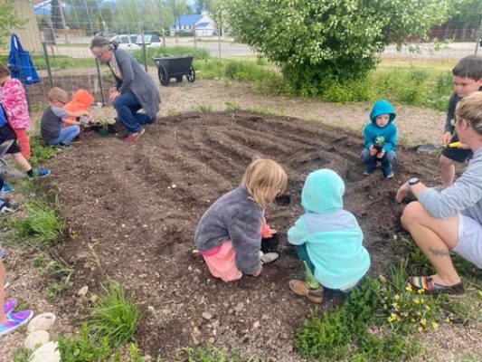 Kids planting in a garden