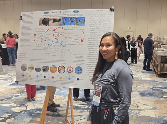 A student in the Department of Family and Consumer Sciences displays her poster at the Native American Nutrition Conference. It is titled: “Food Sovereignty, Experiential Learning and Healing: Integrating Education and Community Health on the Wind River Reservation.”