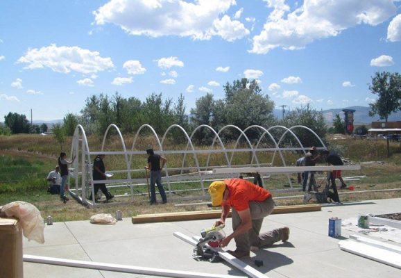 People building a hoop house