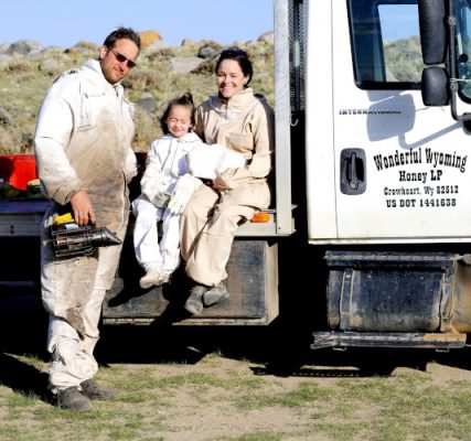 Family sitting on bed of Wonderful Wyoming Honey truck bed