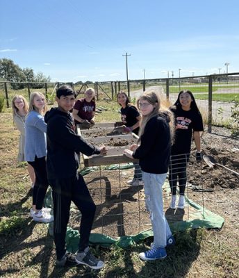 Students working in a garden.