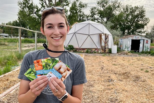 Woman holding packets of seeds.