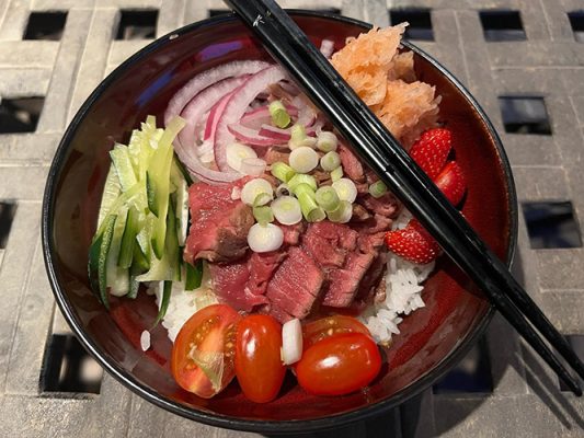 Bowl of food with chopsticks